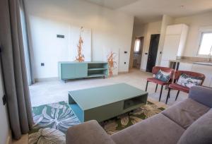 a living room with a couch and a table at ON City Apartments in Matalascañas