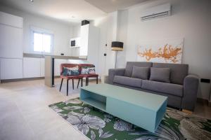 a living room with a couch and a table at ON City Apartments in Matalascañas