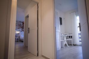 a hallway with a door leading to a living room at Arli Hotel Hideaway Punta Ala - Adults Only in Punta Ala