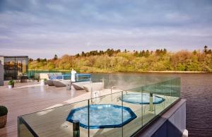 a boat with two hot tubs on the deck at Ice House Hotel in Ballina
