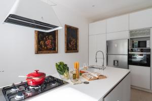a kitchen with a stove with a pot on it at Domus Orestea Luxury Suites in Palermo