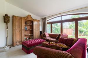 a living room with two couches and a large window at Domus Orestea Luxury Suites in Palermo