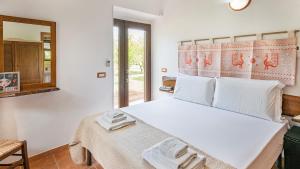 Кровать или кровати в номере Welcomely - Guesthouse Kadossene Alghero