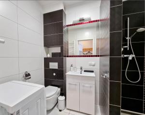 a bathroom with a white toilet and a sink at visit baltic - Apartment Klaudia in Świnoujście