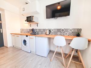 a kitchen with a counter and a washer and dryer at Le Bourget - petit studio - Grenoble in Grenoble