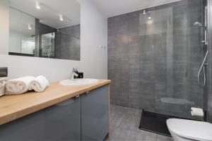 a bathroom with a sink and a shower at Apartament Przystań Letnica by Renters in Gdańsk