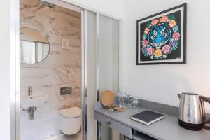 a bathroom with a sink and a toilet and a mirror at 4 Berkeley Square I Your Apartment in Bristol