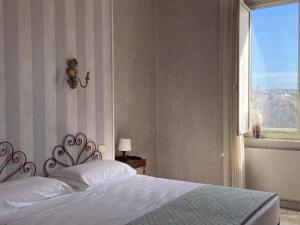 a bedroom with a white bed and a window at Hotel Le Najadi in Santa Marinella +15 photos