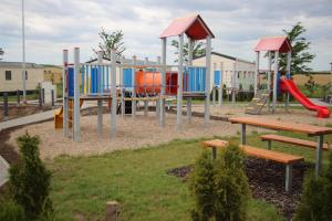 a playground with colorful equipment in a park at Merlin's camp in Znojmo