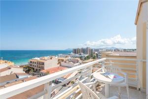 a balcony with a table and a view of the ocean at Nordeste Playa in Can Picafort