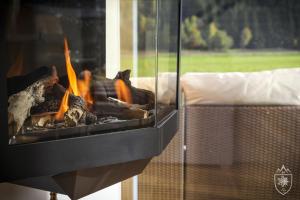 a fire in a fireplace in a room at Feriendorf Murau by ALPS RESORTS in Murau