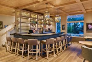 a bar in a restaurant with chairs and tables at Alila Napa Valley in St. Helena