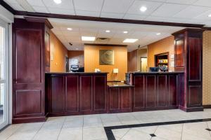 a lobby with brown wood paneling and a bar at Comfort Inn & Suites Denison - Lake Texoma in Denison