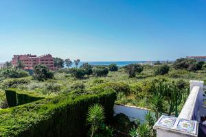 a view of the ocean from the balcony of a house at Villa Jardin Tropical in Manilva