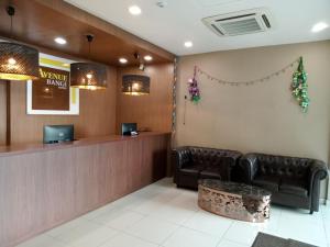 a waiting room with leather chairs and a counter at AVENUE BANGI HOTEL in Kajang