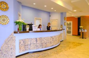 two women sitting at a bar in a lobby at Hotel Baglio Di Scopello in Scopello +37 photos