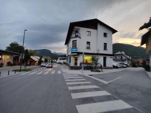 a crosswalk in the middle of a street with a building at House Budkovič in Bohinj