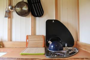 a kitchen counter with a tea kettle on a stove at The shepherds hut in Shrewsbury