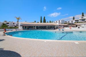 a large swimming pool in front of a building at São Rafael Praia in Albufeira