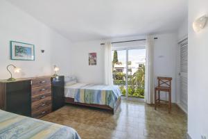 a bedroom with a bed and a dresser and a window at São Rafael Praia in Albufeira +24 photos