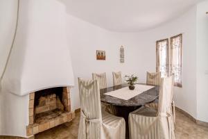a dining room with a table and a fireplace at São Rafael Praia in Albufeira