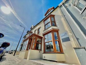 a building with windows on the side of a street at gwesTY Guest House in Aberystwyth