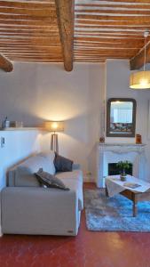 a living room with a couch and a tv at Hotel Relais Du Postillon in Antibes