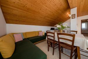 a living room with a couch and a table at Apartments Tartuga in Rab