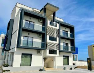 a tall white building with balconies on it at Solemar Boutique in Eforie Sud