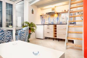 a kitchen with white cabinets and a table and chairs at Sweet Sissi in Ljubljana