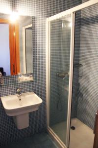 a bathroom with a shower, sink, and mirror at Curral de l Tiu Pino in Sendim