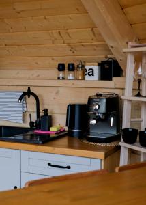 a kitchen with a counter with a coffee maker on it at Osada Poli - domek 4 in Koniaków