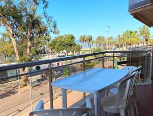 a blue table and chairs on a balcony at El Pinar Fuente Luminosa in Salou
