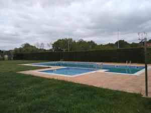 an empty swimming pool in a grassy field at Lar Toxiño in Ourense