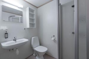a bathroom with a sink and a toilet and a mirror at Nermo Hotel & Apartments in Hafjell