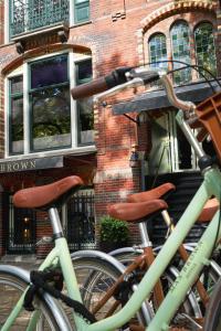zwei Fahrräder, die vor einem Backsteingebäude geparkt sind in der Unterkunft Max Brown Hotel Museum Square, part of Sircle Collection in Amsterdam
