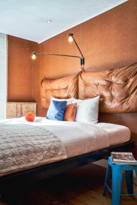 - une chambre avec un grand lit et une tête de lit marron dans l'établissement Max Brown Hotel Museum Square, part of Sircle Collection, à Amsterdam