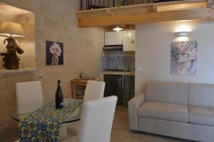 a living room with a table and a couch at Corte Soleto 22 in Martano