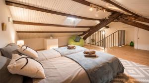 a bedroom with a large bed in a attic at Casa Emiliana in Raša
