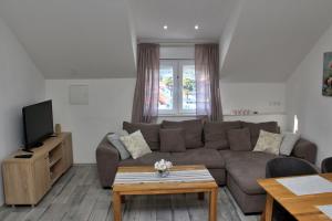 ein Wohnzimmer mit Sofa und Fernseher in der Unterkunft Apartments Mara in Jelsa + 33 Fotos