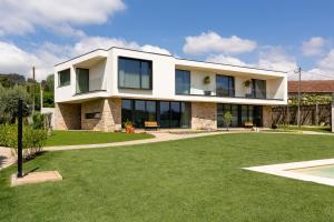 a white house with a lawn in front of it at Casas Casal de Nino in Celorico de Basto