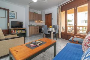 a living room with a table and a dining room at Casa Miriam in Cala Ratjada