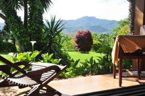 a patio with a chair and a view of a yard at CASA MENDILORE in Hondarribia