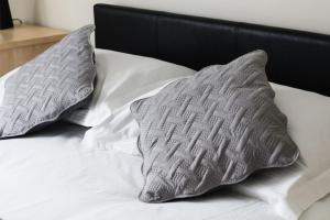 two pillows sitting on top of a bed at 18 Sea View Close in Scarborough
