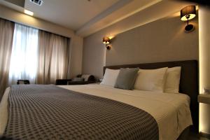 A bed or beds in a room at Aiolos Apartments Suites Ermou 64 Monastiraki Plaka 2nd Floor