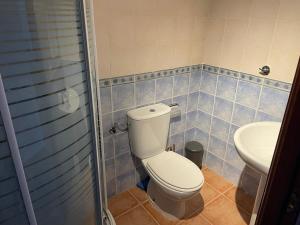 a bathroom with a toilet and a sink at Alojamiento EL BUTAKA in Cala +11 photos