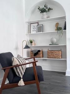 a living room with a chair and shelves at Inxpress Luxury Apartment Driffield in Great Driffield