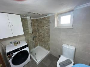 a small bathroom with a shower and a toilet at Chania Nice Apartment 3 in Chania Town +6 photos