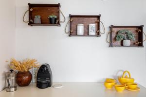 a kitchen counter with two wooden shelves on the wall at #FLH - Vitamin Sea Beachfront Villa, Sithonia in Metamorfosi