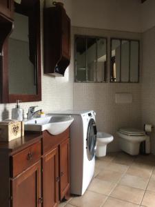 a bathroom with a washing machine and a sink at La Dolce Vita in Meina